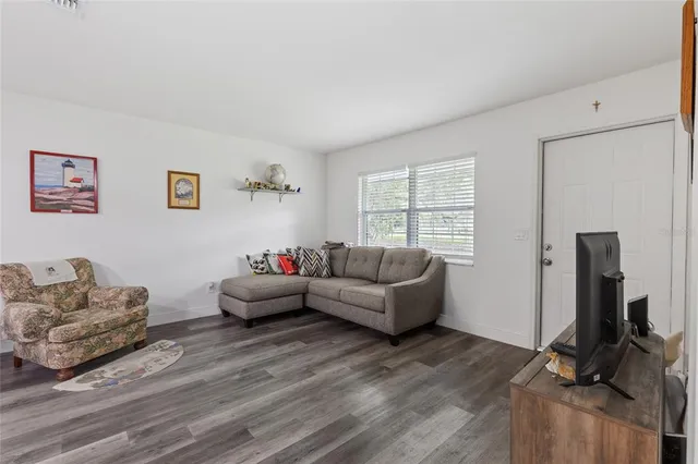 a living room with furniture window and wooden floor