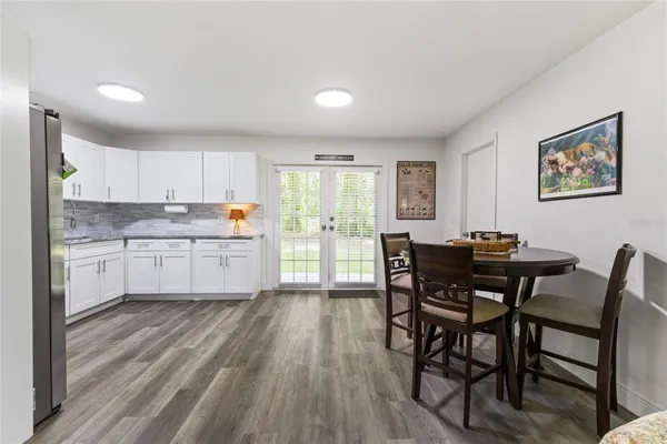 a kitchen with a table chairs sink and cabinets