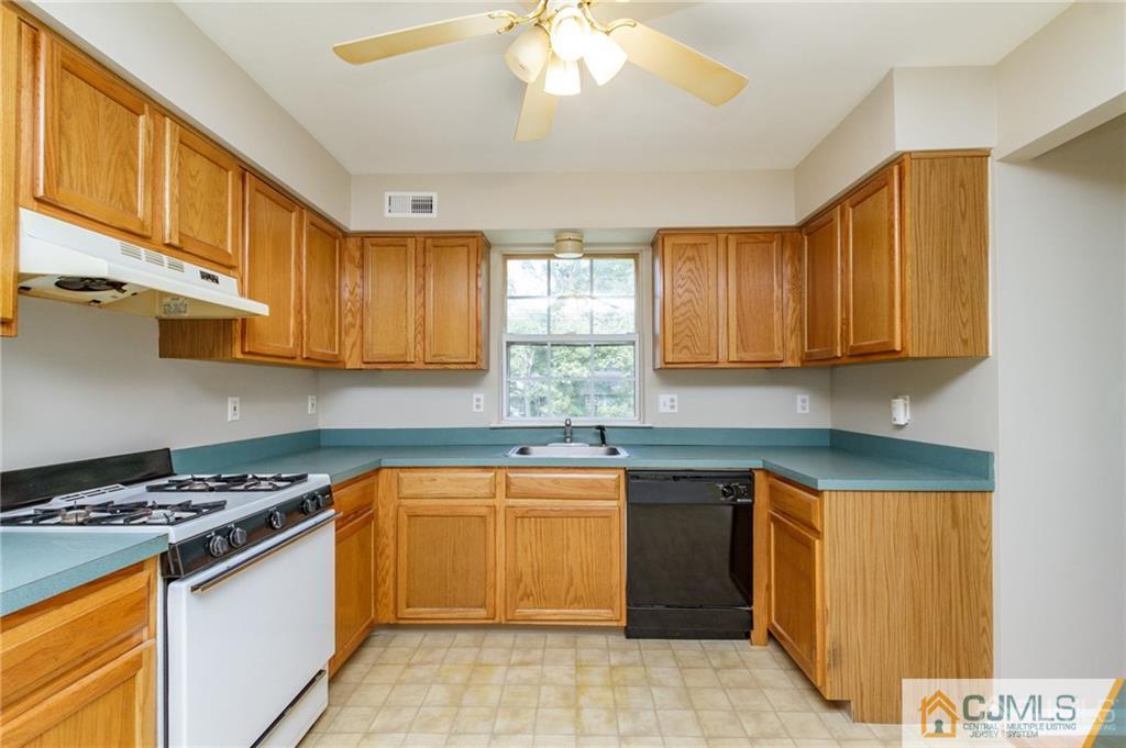 149 Brigantine Road Manahawkin, NJ 08050 - Photo 13 of 29 a kitchen with stainless steel appliances granite countertop a stove sink and cabinets
