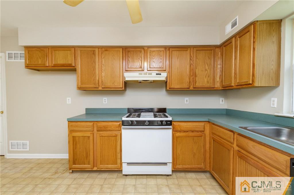 149 Brigantine Road Manahawkin, NJ 08050 - Photo 15 of 29 a kitchen with stainless steel appliances granite countertop a stove a sink and a microwave
