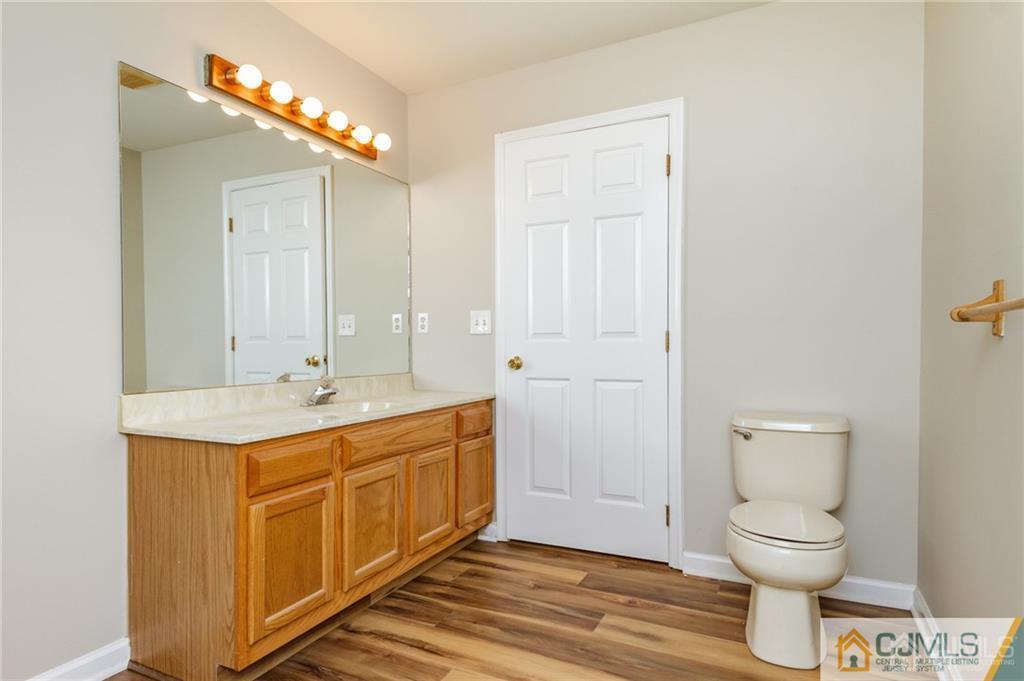 149 Brigantine Road Manahawkin, NJ 08050 - Photo 21 of 29 a bathroom with a toilet sink and mirror