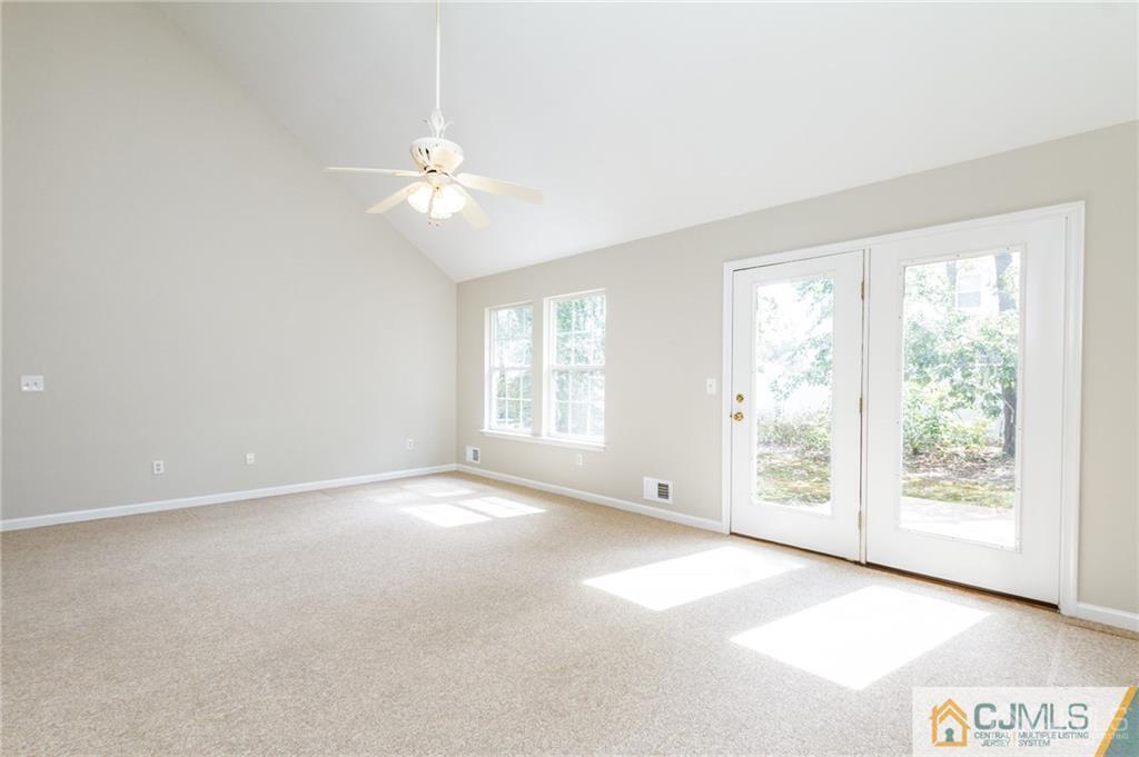 149 Brigantine Road Manahawkin, NJ 08050 - Photo 7 of 29 an empty room with windows and ceiling fan