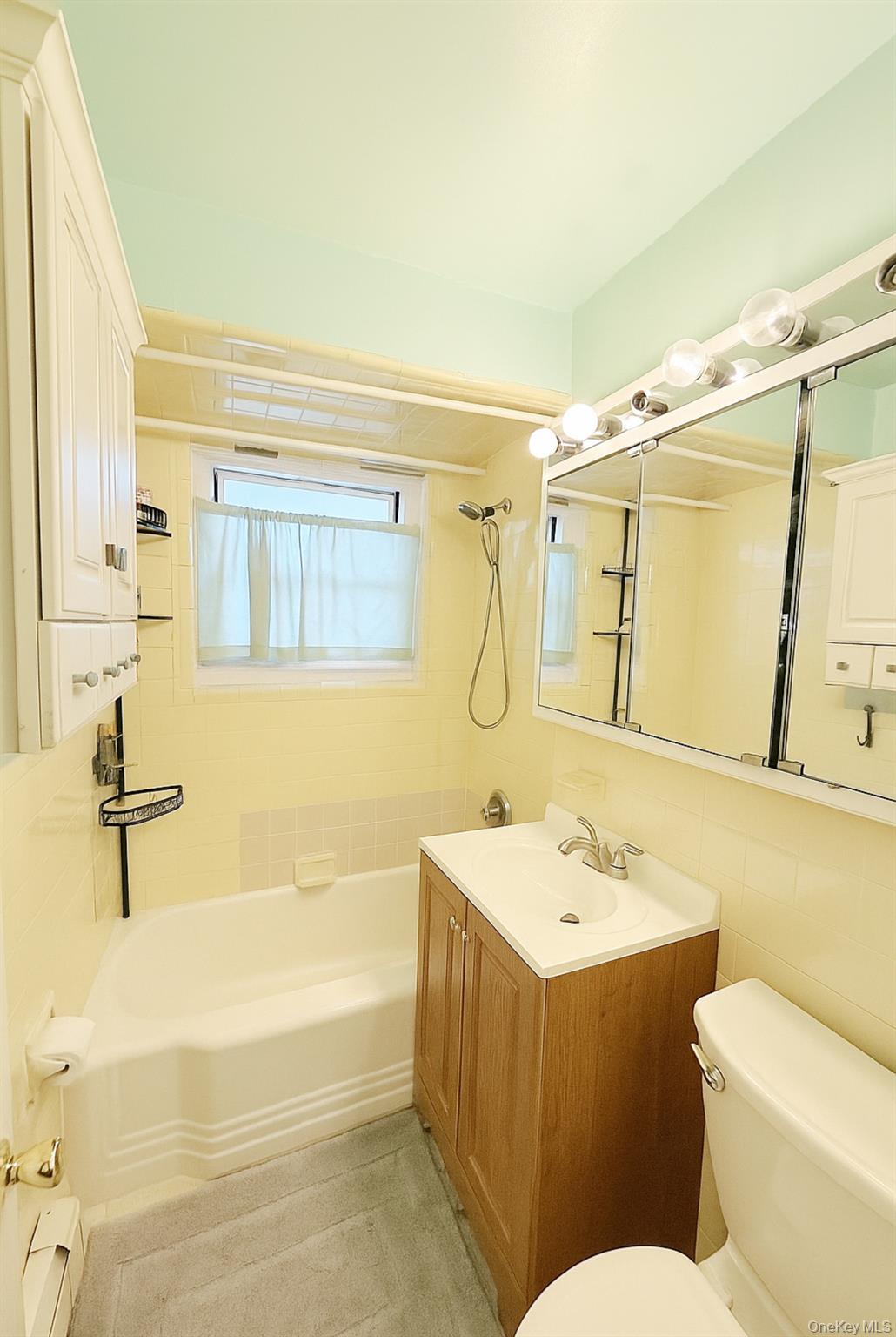14930 Melbourne Avenue, Unit 395A Queens, NY 11367 - Photo 6 of 8 a bathroom with a sink a toilet and shower