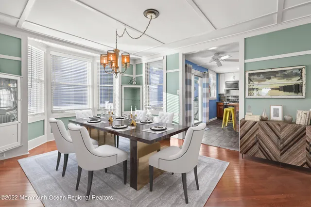 a view of a dining room with furniture wooden floor and chandelier