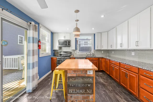 a kitchen with stainless steel appliances granite countertop a sink and cabinets