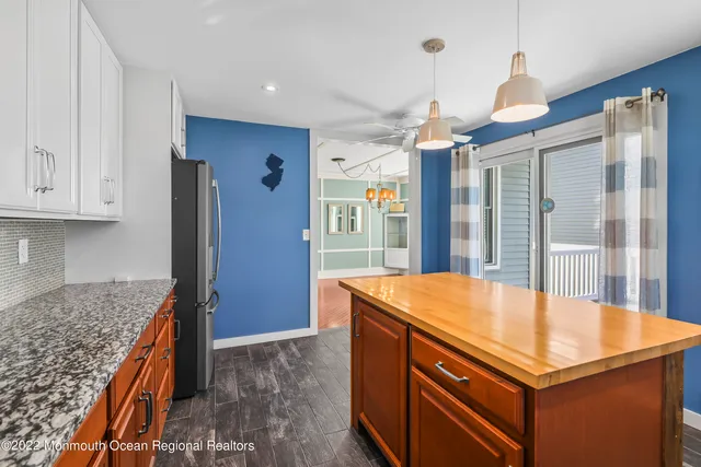 a room with pool table and windows