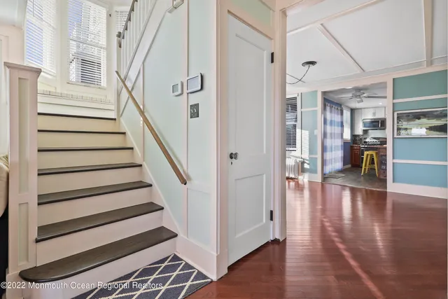 a view of entryway and hall with wooden floor