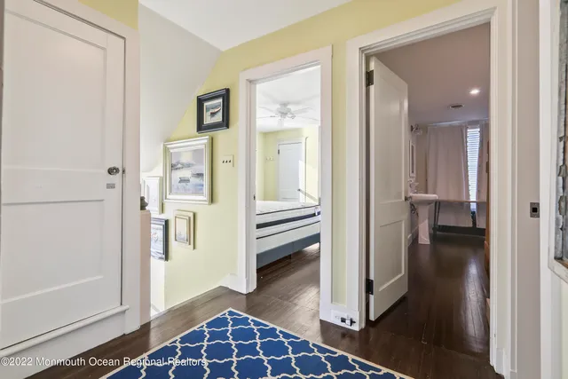 a view of a hallway with wooden floor and closet