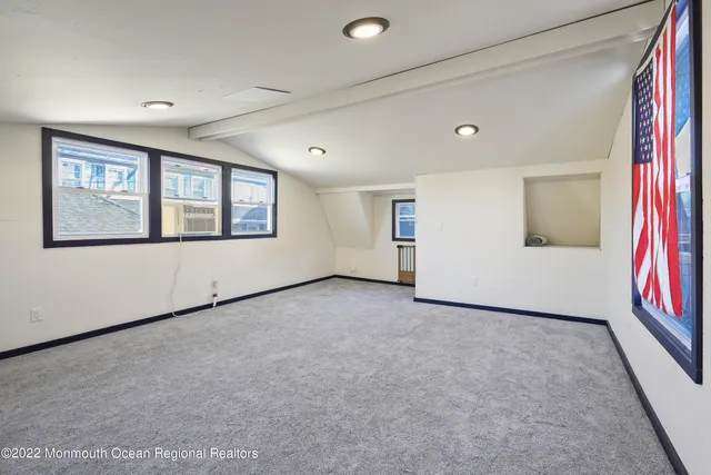 a view of a big room with windows and chandelier
