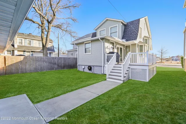 a view of a house with a yard and deck
