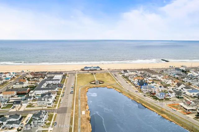 an aerial view of residential building and ocean