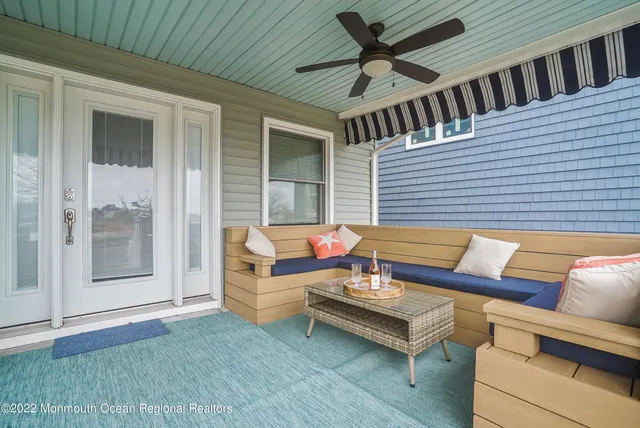 a outdoor living space with furniture and a book shelf