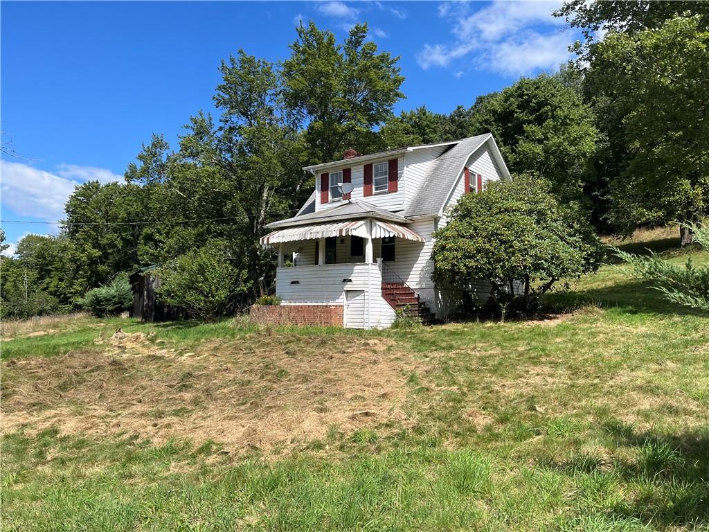 1101 Pine Road Kittanning, PA 16201 - Photo 1 of 14 a white house that has a big yard with large trees
