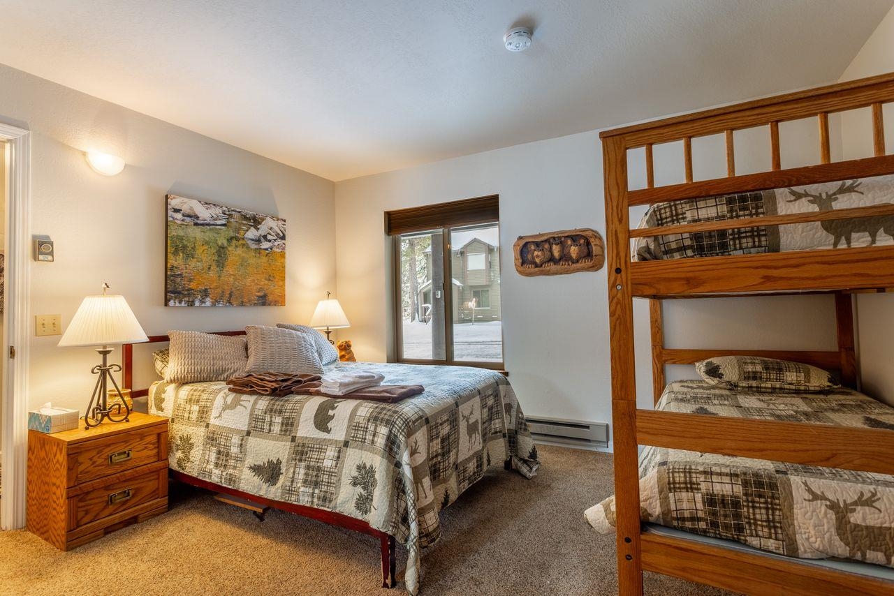 384 Joaquin Road, Unit 38 Mammoth Lakes, CA 93546 - Photo 25 of 30 a bedroom with a bed and a lamp on dresser