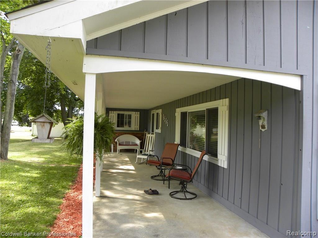 6565 Walters Road Clarkston, MI 48346 - Photo 14 of 40 Massive covered concrete porch is an impressive entryway.