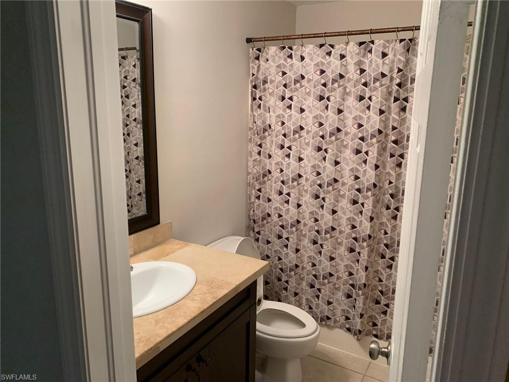 2075 17th Street Southwest Naples, FL 34117 - Photo 7 of 13 a bathroom with a granite countertop sink and a toilet