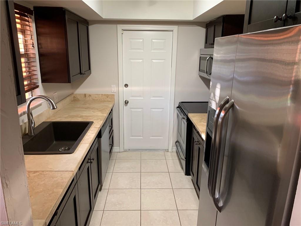 2075 17th Street Southwest Naples, FL 34117 - Photo 9 of 13 a storage room with washer and dryer