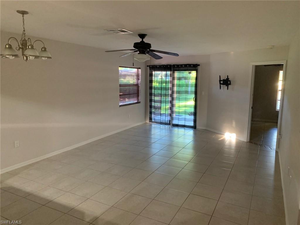 2075 17th Street Southwest Naples, FL 34117 - Photo 10 of 13 an empty room with wooden floor and windows