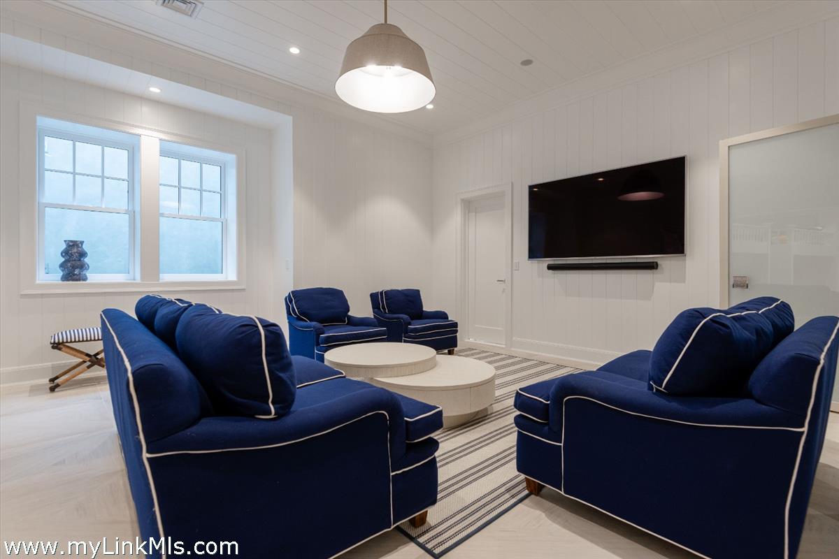 37 Sankaty Head Road Nantucket, MA 02554 - Photo 47 of 65 a living room with furniture a flat screen tv and a window