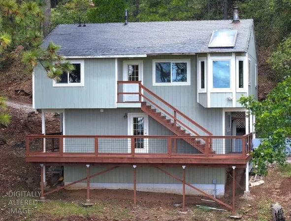 a house that has a wooden fence and a table chair