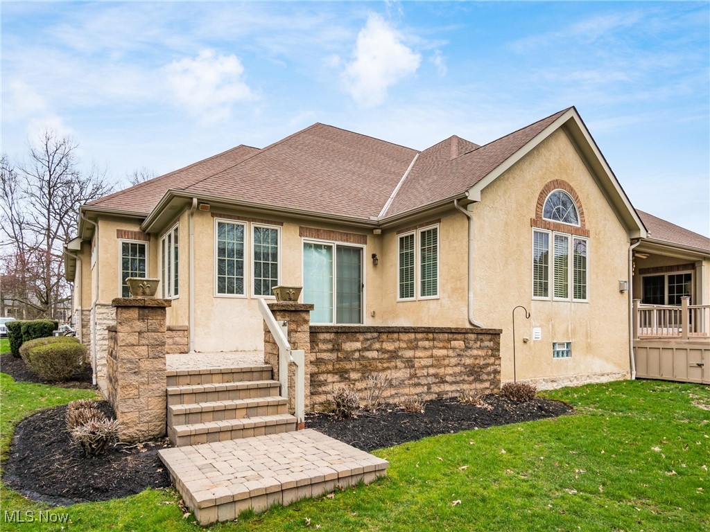 5349 Slater Ridge Westerville, OH 43082 - Photo 44 of 50 View of front of property featuring stucco siding, a shingled roof, a front lawn, and stone siding