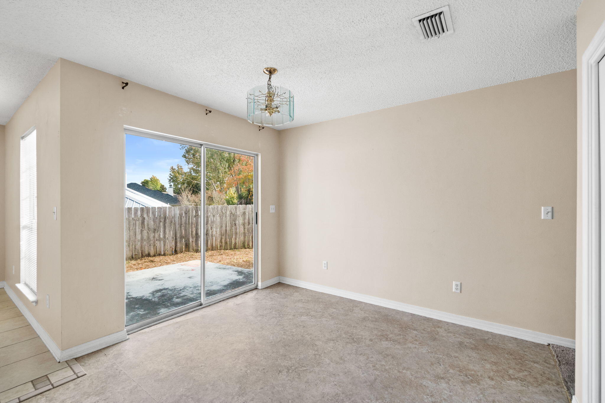 3607 Goldsbys Way Destin, FL 32541 - Photo 14 of 26 en empty room with wooden floor and windows