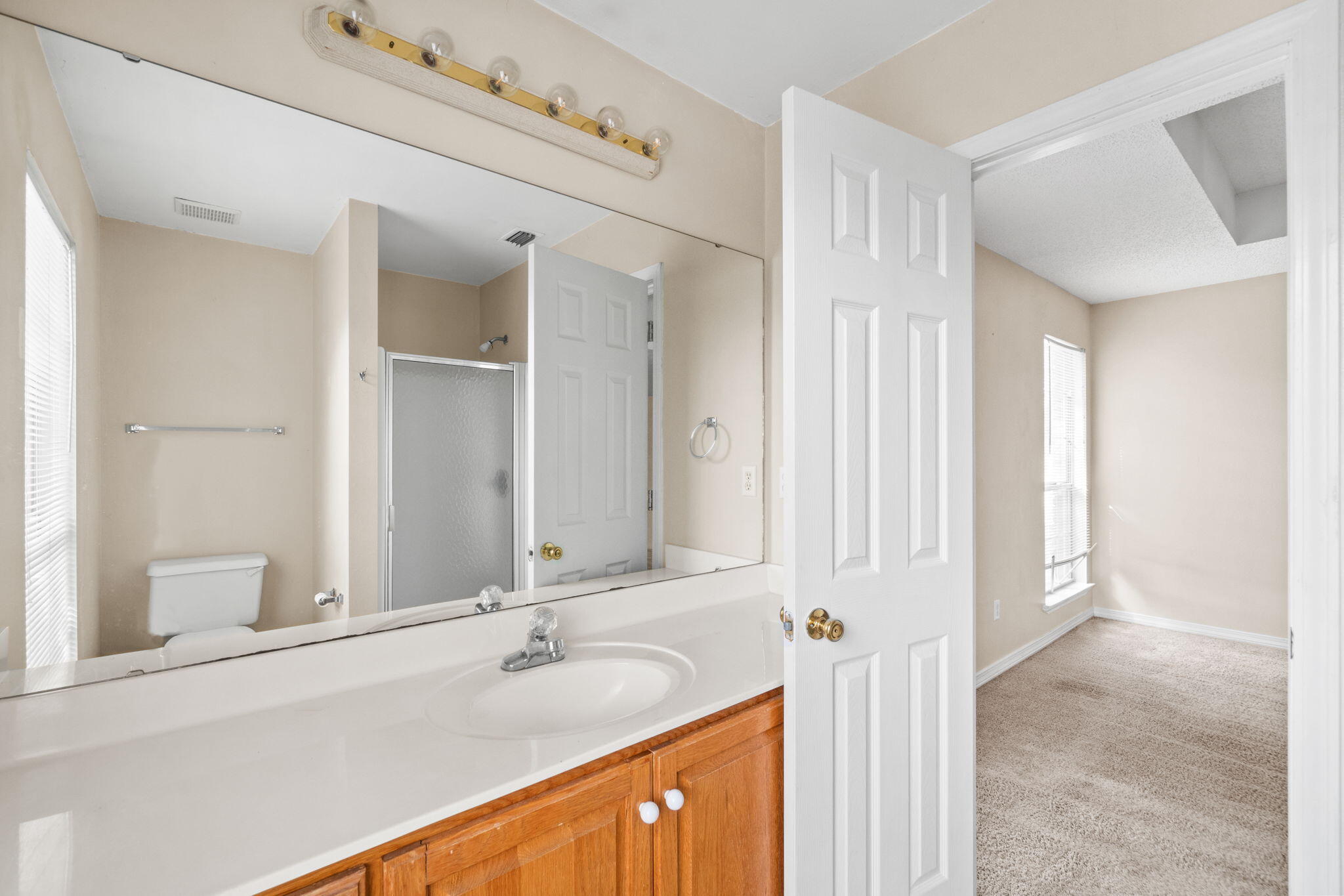 3607 Goldsbys Way Destin, FL 32541 - Photo 23 of 26 a bathroom with a granite countertop sink and a mirror