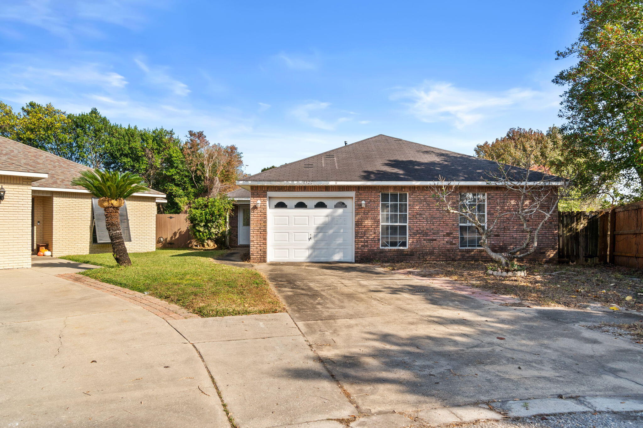 3607 Goldsbys Way Destin, FL 32541 - Photo 3 of 26 a front view of a house with a garden and trees