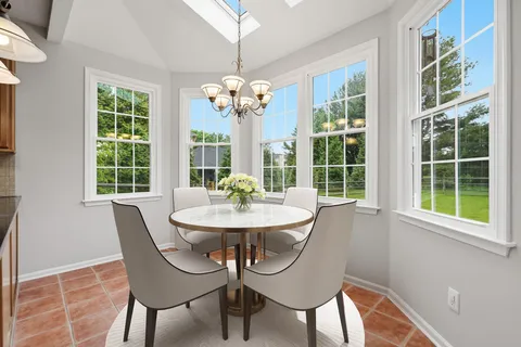 a view of a dining room with furniture wooden floor and chandelier
