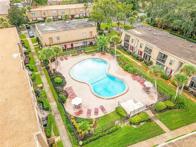 an aerial view of residential house with outdoor space and swimming pool