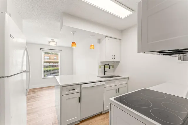 a kitchen with a sink stove and refrigerator