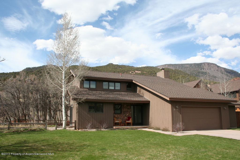 230 Riverside Drive Basalt, CO 81621 - Photo 12 of 12 a view of a white house with a big yard and large tree