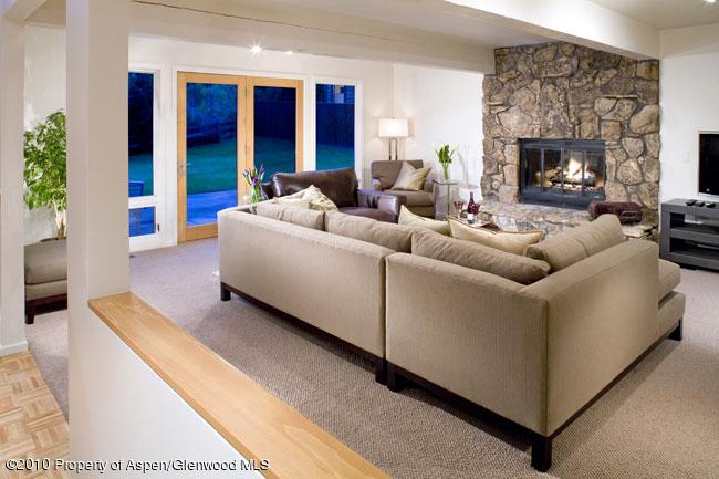 230 Riverside Drive Basalt, CO 81621 - Photo 3 of 12 a living room with furniture a fireplace and a floor to ceiling window