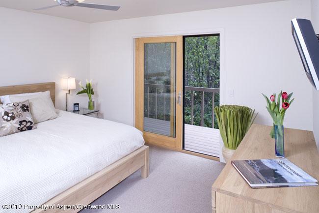 230 Riverside Drive Basalt, CO 81621 - Photo 6 of 12 a bedroom with a bed and a large window