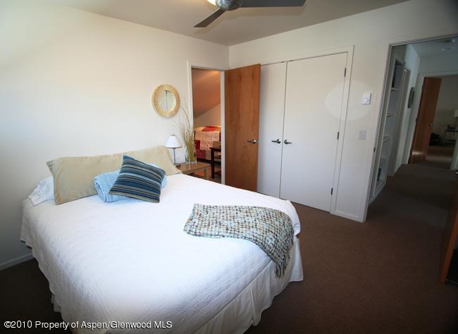 230 Riverside Drive Basalt, CO 81621 - Photo 10 of 12 a bed sitting in a bedroom and wooden floor