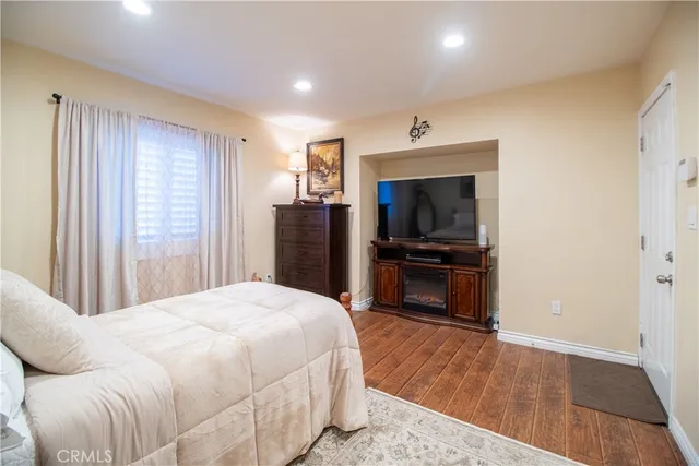 a bedroom with a bed and a television