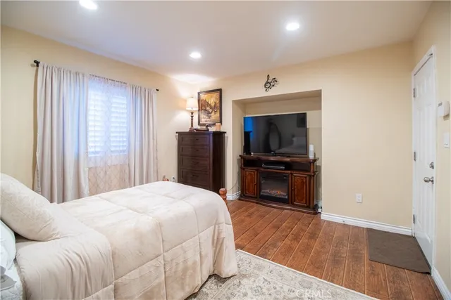 a bedroom with a bed and a television