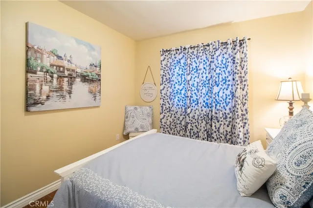 a bedroom with a bed and a wall painting