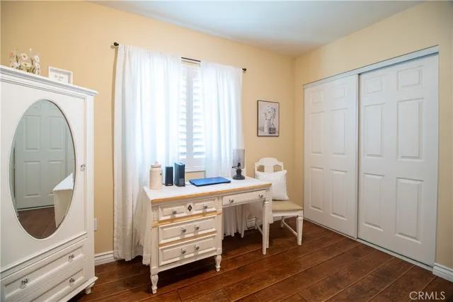 a view of a bedroom with furniture and wooden floor