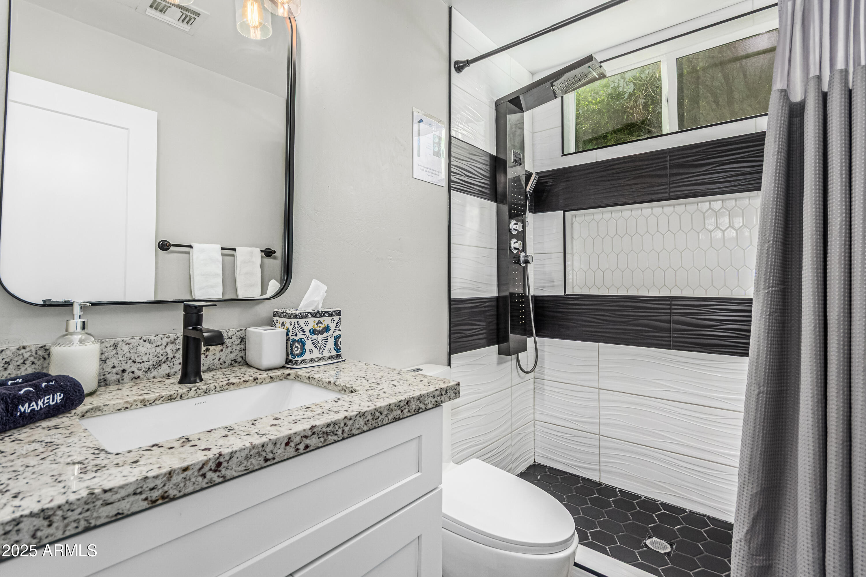 3438 North 30th Street Phoenix, AZ 85016 - Photo 14 of 26 a bathroom with a granite countertop sink mirror vanity and toilet