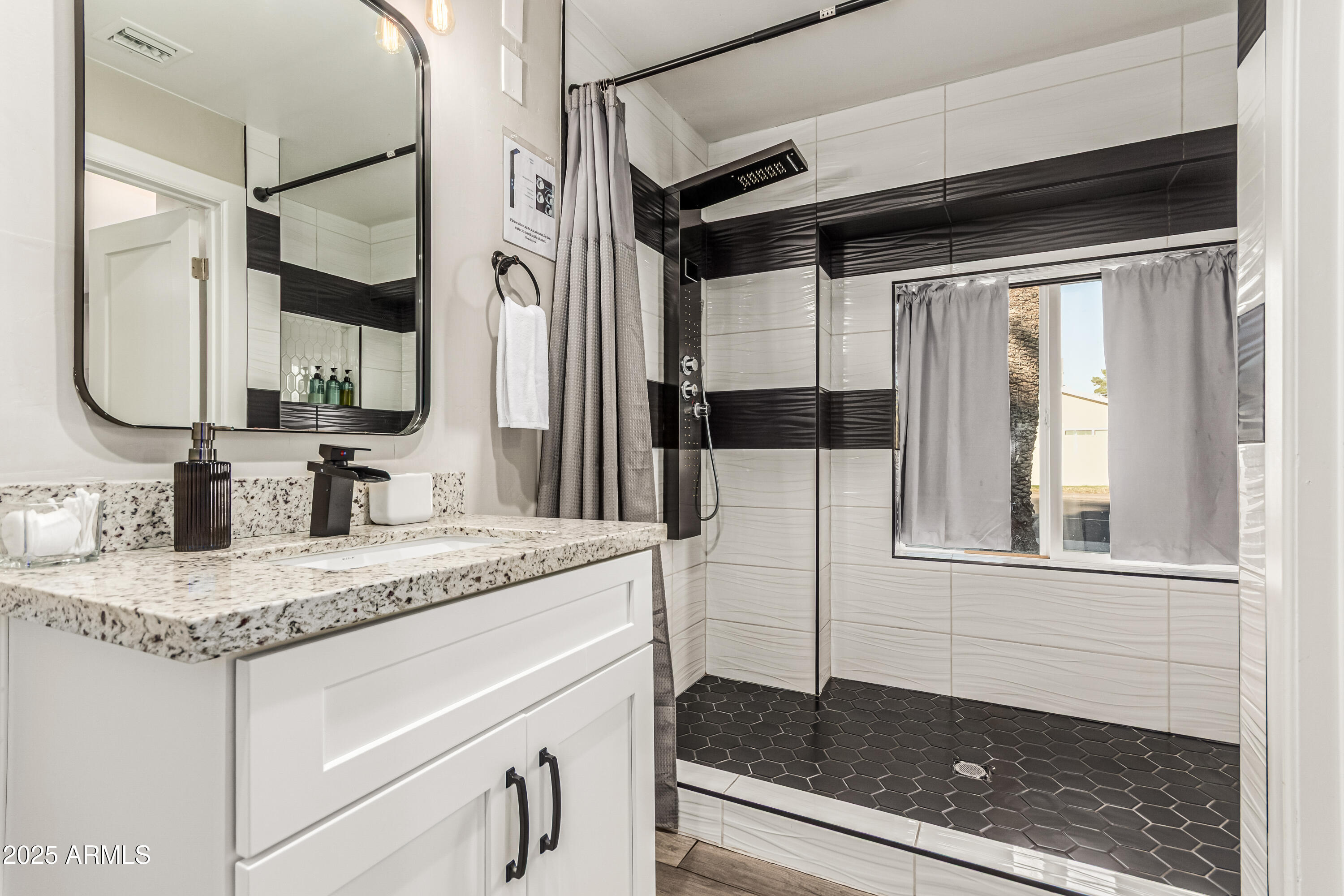 3438 North 30th Street Phoenix, AZ 85016 - Photo 18 of 26 a bathroom with a granite countertop sink a mirror and shower