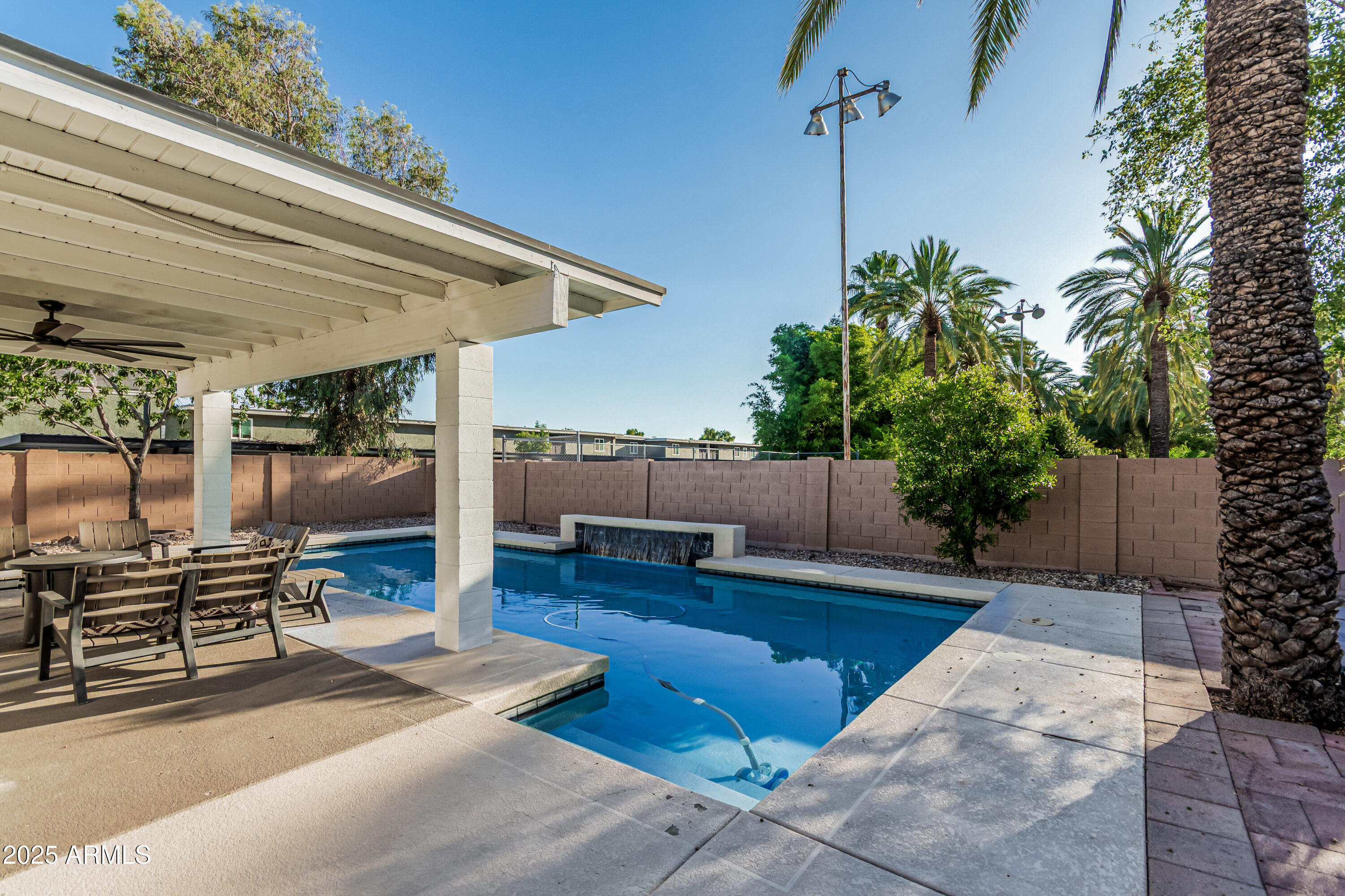 3438 North 30th Street Phoenix, AZ 85016 - Photo 23 of 26 a view of a patio with table and chairs potted plants with wooden floor