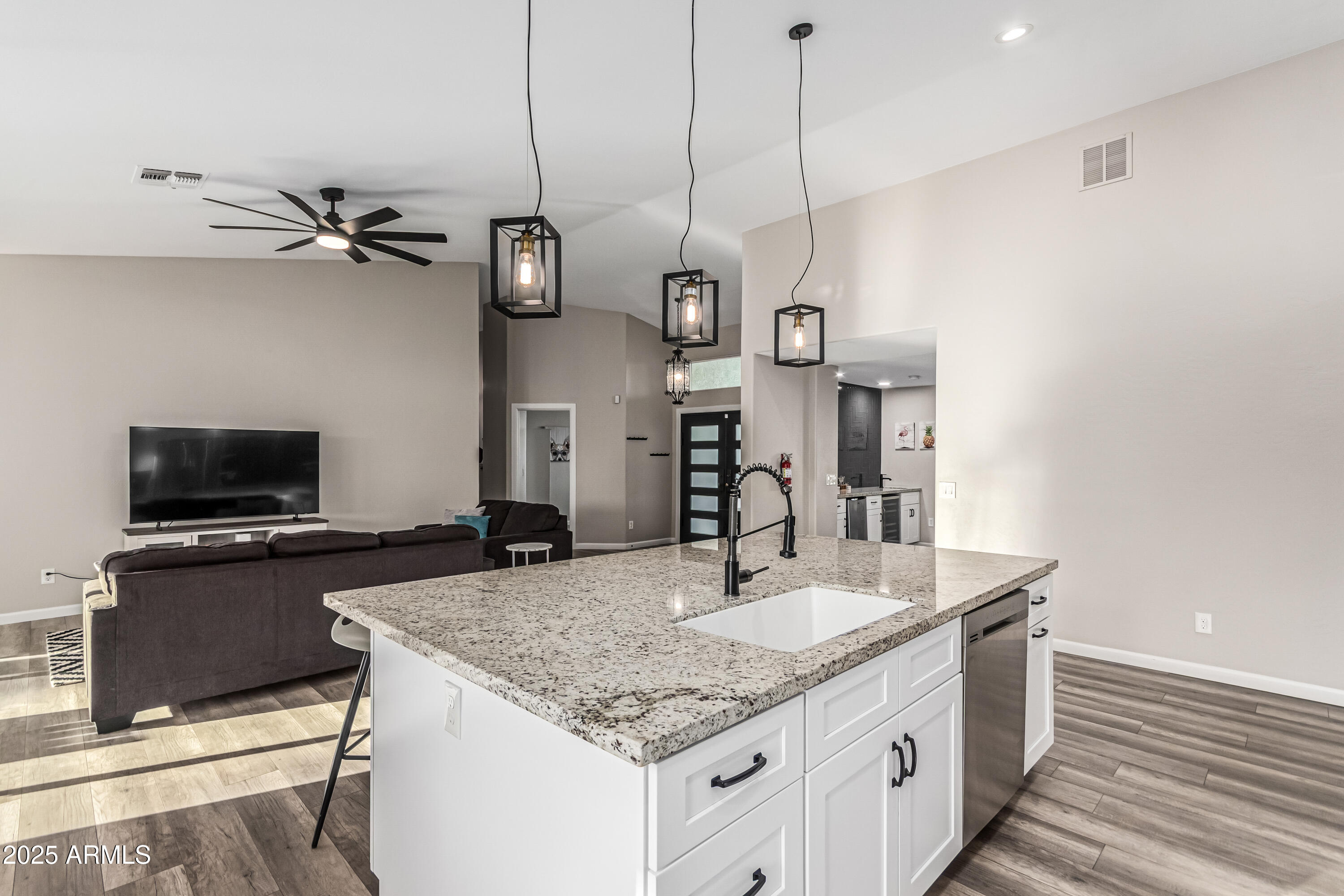 3438 North 30th Street Phoenix, AZ 85016 - Photo 8 of 26 a kitchen with kitchen island granite countertop a sink a counter top space appliances and cabinets