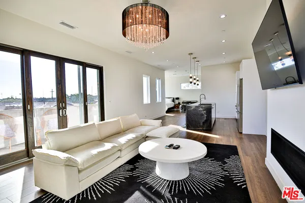 a living room with furniture and a chandelier