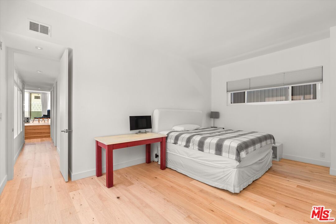 854 18th Street, Unit 6 Santa Monica, CA 90403 - Photo 11 of 22 a bedroom with a bed and a table