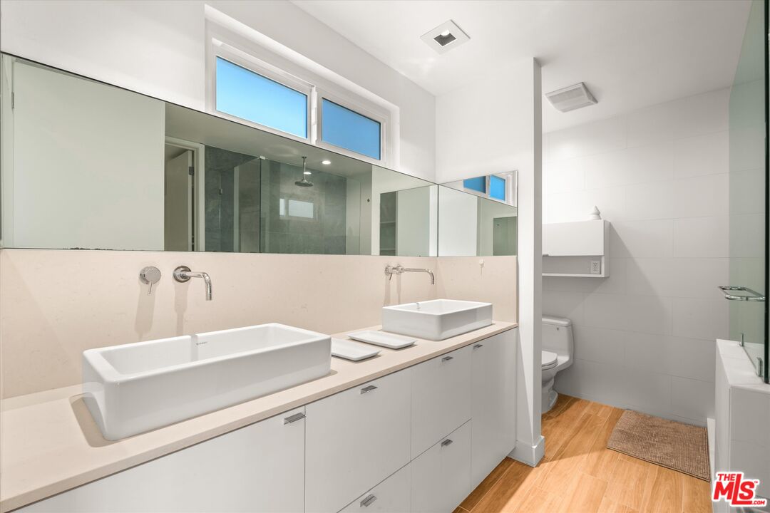 854 18th Street, Unit 6 Santa Monica, CA 90403 - Photo 13 of 22 a bathroom with a sink and a mirror