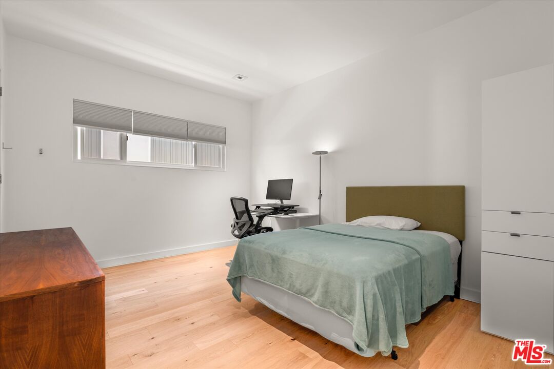 854 18th Street, Unit 6 Santa Monica, CA 90403 - Photo 16 of 22 a bedroom with a bed and wooden floor