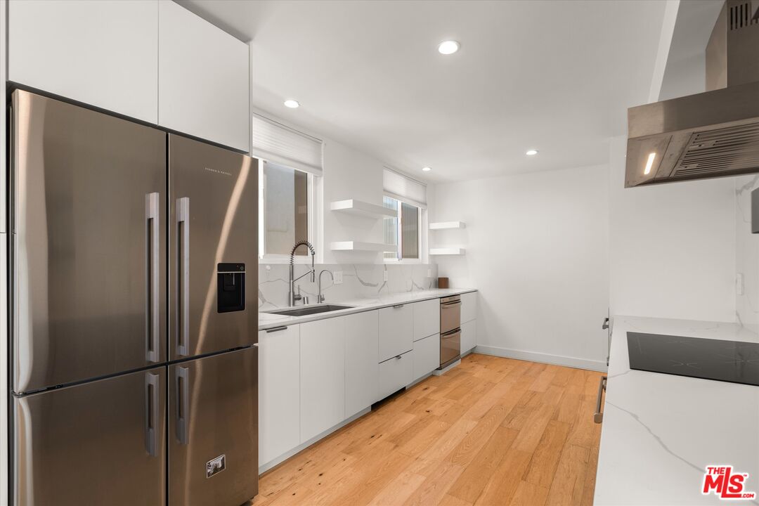 854 18th Street, Unit 6 Santa Monica, CA 90403 - Photo 8 of 22 a kitchen with a refrigerator and a sink