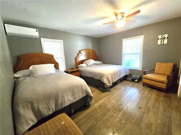 a bedroom with two beds and a chandelier