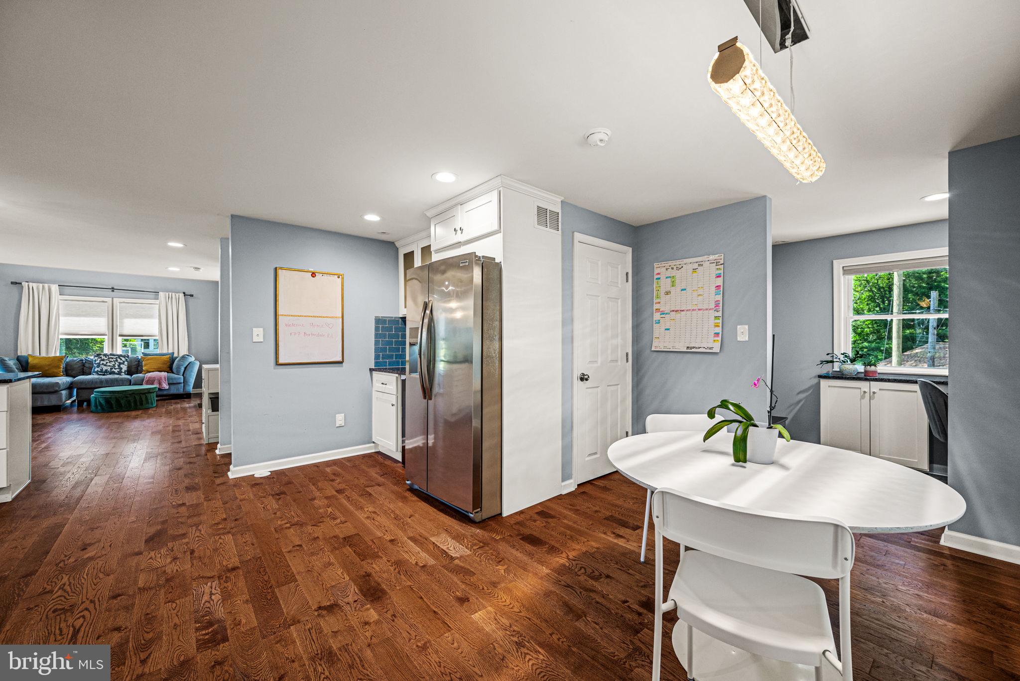 177 Bortondale Road Media, PA 19063 - Photo 16 of 33 a living room with furniture and a dining table with wooden floor